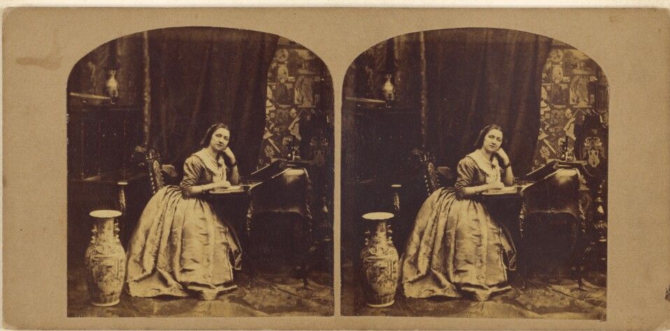 "Woman seated at writing table, hand on open book," photo by Joseph John Elliott (1835-1903). The J. Paul Getty Museum, Los Angeles (Image released under CC0).